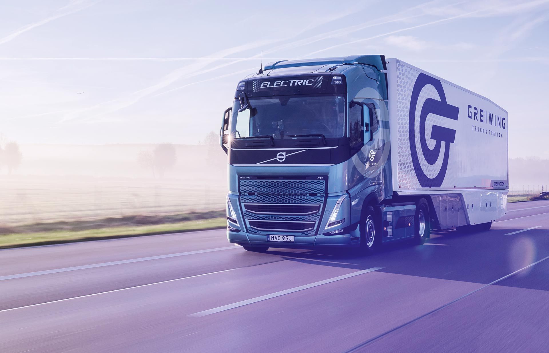 Greiwing branded electric truck and trailer on the highway