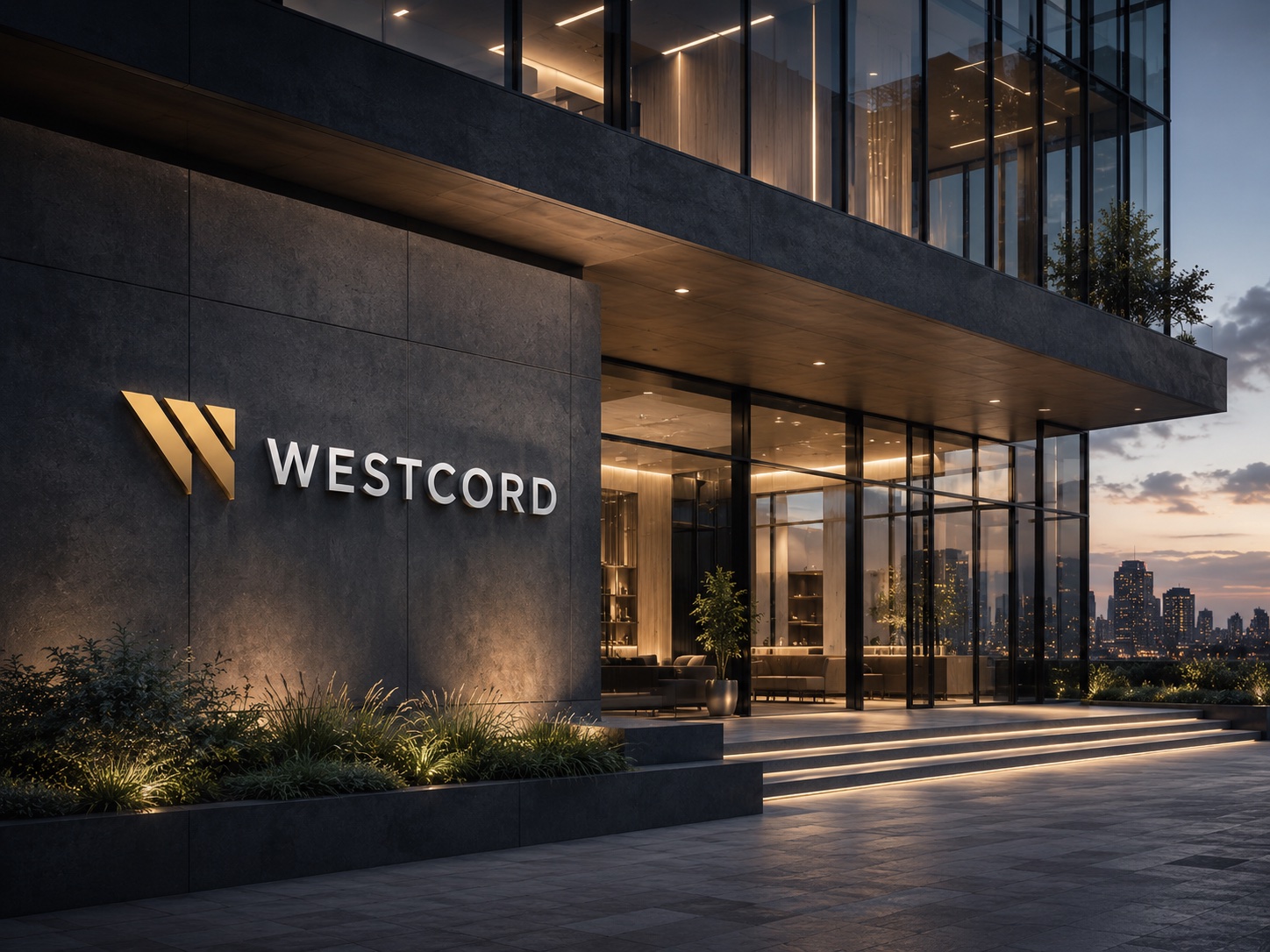 Westcord illuminated building facade at dusk with gold W mark and Westcord wordmark above a glass lobby entrance, city skyline behind.