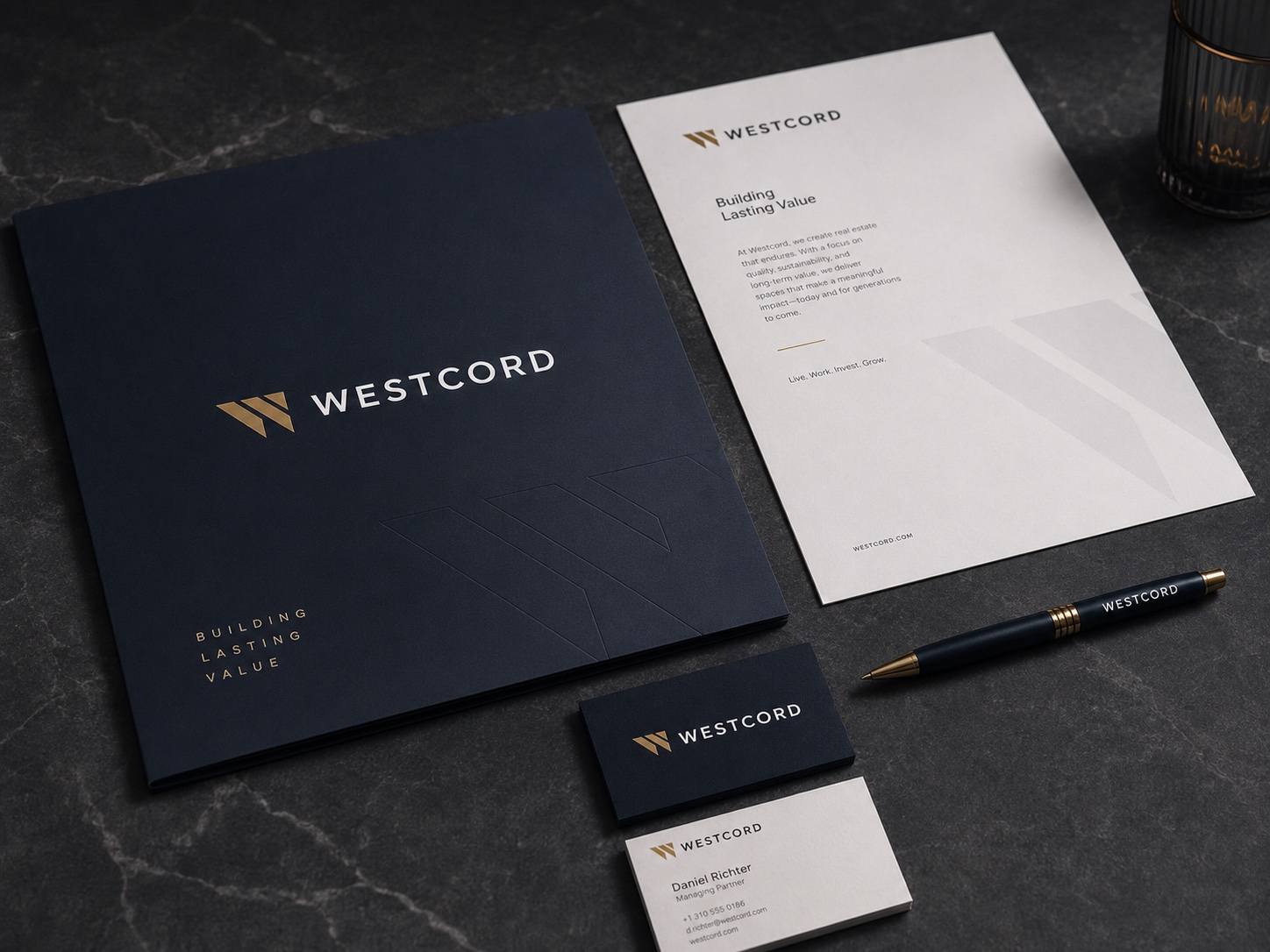 Westcord corporate stationery flatlay with embossed folder, letterhead reading 'Building Lasting Value' and a branded pen.
