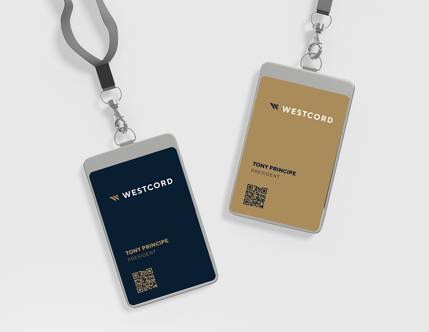 Two Westcord employee ID badges on lanyards, one navy and one gold, each with a QR code.