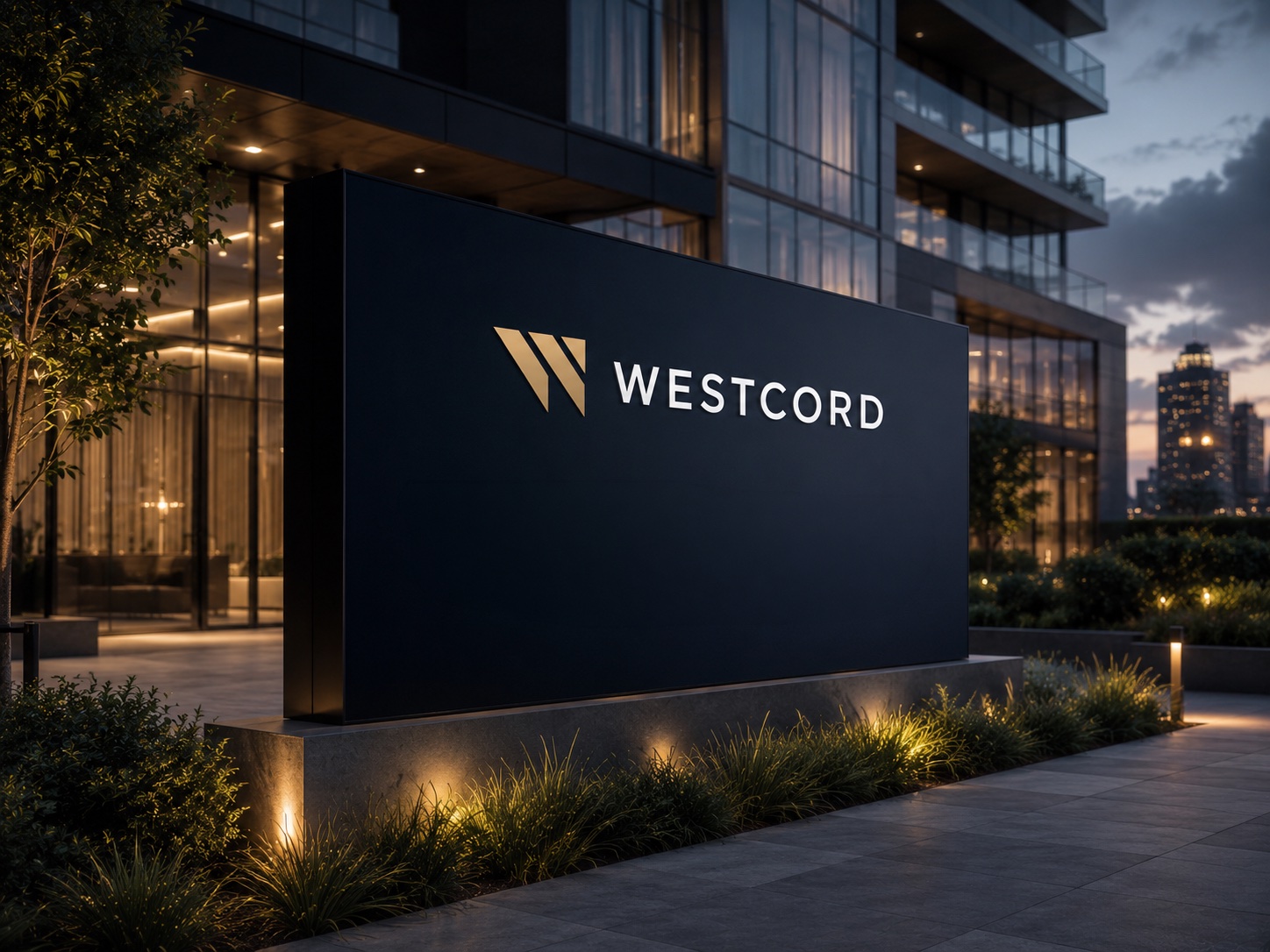 Westcord monument sign reading 'Premium Residences. Live. Work. Invest. Grow.' outside a glass building at dusk.