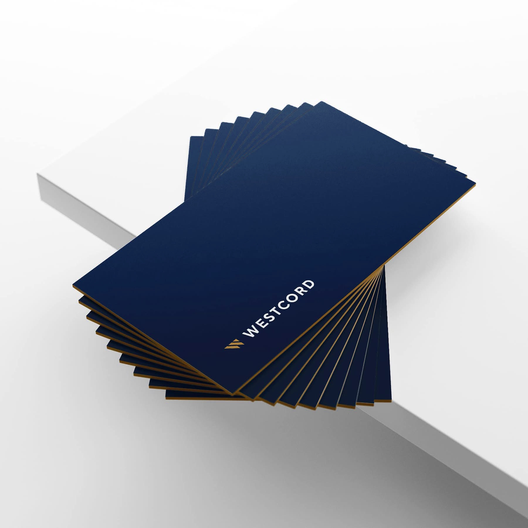 Fanned stack of navy and gold Westcord business cards showing the W mark and wordmark.