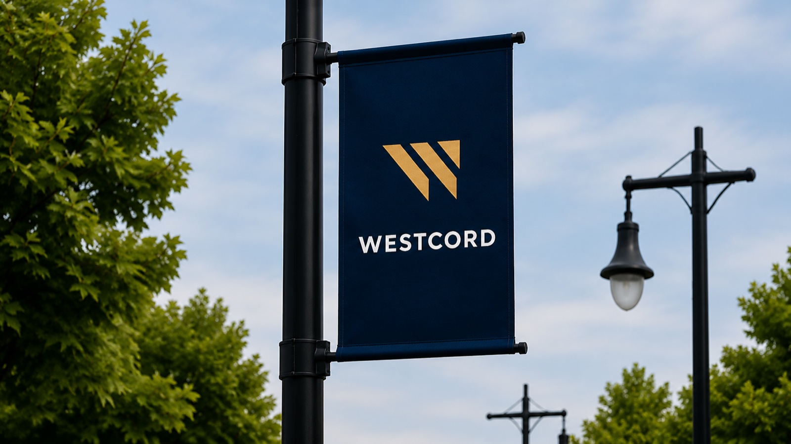 Westcord street pole banner in navy and gold outside a commercial property.